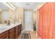 Bathroom with double sink vanity, white door, neutral paint and decorative shower curtain at 509 Fallen Leaf Ct., Myrtle Beach, SC 29588