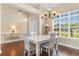 Bright dining room featuring a white table set, chandelier, and large windows at 509 Fallen Leaf Ct., Myrtle Beach, SC 29588