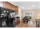 Modern kitchen with dark cabinetry, black appliances, and a breakfast nook with sliding doors at 509 Fallen Leaf Ct., Myrtle Beach, SC 29588