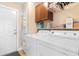 Laundry room featuring front load washer and dryer and utility cabinets above at 509 Fallen Leaf Ct., Myrtle Beach, SC 29588