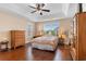 Serene primary bedroom featuring tray ceilings, hardwood flooring, and large windows at 509 Fallen Leaf Ct., Myrtle Beach, SC 29588