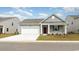 Charming single-story home featuring a two-car garage and a well-maintained front lawn at 5140 Yellowstone Dr., Conway, SC 29526