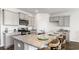 Kitchen island with light gray cabinets and granite countertop seating three; stainless steel appliances at 5140 Yellowstone Dr., Conway, SC 29526