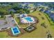 Aerial view showcases a community pool, tennis court, playground, and lush landscaping at 5371 Knobcone Loop # D, Myrtle Beach, SC 29577