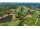 Beautiful aerial view of a golf course with pristine greens, scenic ponds, and distant ocean view at 5371 Knobcone Loop # D, Myrtle Beach, SC 29577