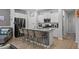 Spacious kitchen featuring stainless appliances, an island with bar seating and white cabinets at 5371 Knobcone Loop # D, Myrtle Beach, SC 29577