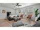 Well-lit living room features an oversized rug, modern ceiling fan, and stylish furnishings at 5371 Knobcone Loop # D, Myrtle Beach, SC 29577