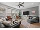 Bright living room with plenty of natural light, modern ceiling fan, and hardwood floors at 5371 Knobcone Loop # D, Myrtle Beach, SC 29577