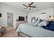 Comfortable main bedroom featuring a king-size bed, wooden floors, and an adjoining bathroom and staircase at 5371 Knobcone Loop # D, Myrtle Beach, SC 29577