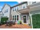 Charming patio area with outdoor dining, welcome mat, and a decorative green privacy fence at 5371 Knobcone Loop # D, Myrtle Beach, SC 29577
