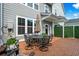 Relaxing patio with dining furniture, green privacy screen, and a quaint welcome sign at 5371 Knobcone Loop # D, Myrtle Beach, SC 29577