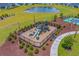 Aerial view of a playground with slides, surrounded by lush landscaping at 5371 Knobcone Loop # D, Myrtle Beach, SC 29577