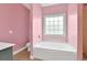 Bathroom featuring a garden tub, a shower, and a big window at 561 Irees Way, Longs, SC 29568