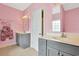 Charming bathroom featuring dual vanities, mirrors, and pink walls providing a cozy and stylish space at 561 Irees Way, Longs, SC 29568