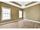 Empty bedroom showcasing a tray ceiling, bright lighting, and neutral decor at 561 Irees Way, Longs, SC 29568