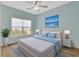 Inviting bedroom with a ceiling fan, a large window, a comfortable bed, and matching nightstands at 561 Irees Way, Longs, SC 29568