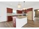 Spacious kitchen featuring an island with granite countertops and modern lighting fixtures at 561 Irees Way, Longs, SC 29568
