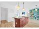 Kitchen island features granite countertops, with a decorative shelving unit in a large open space at 561 Irees Way, Longs, SC 29568