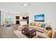Open-concept living room with wood-look tile flooring and open access to kitchen and dining area at 561 Irees Way, Longs, SC 29568