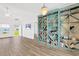 Open-concept living room with large decorative shelving unit and lots of natural light at 561 Irees Way, Longs, SC 29568