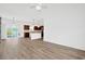 Open-concept living room with wood-look tile flooring and open access to kitchen and dining area at 561 Irees Way, Longs, SC 29568