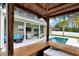 A covered outdoor kitchen is visible from the tiki bar in this backyard with a swimming pool and patio at 561 Irees Way, Longs, SC 29568