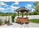 Backyard tiki bar and outdoor shower are visible in this photo, along with a white fence and professional landscaping at 561 Irees Way, Longs, SC 29568