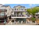 Beautiful waterfront home featuring multiple decks, outdoor furniture, and stunning water views at 6001-308 South Kings Hwy., Myrtle Beach, SC 29575