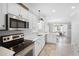 Well-lit kitchen showcasing stainless appliances, white cabinets, and seamless access to dining area at 6001-308 South Kings Hwy., Myrtle Beach, SC 29575