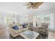 Bright living room with beachy decor, ceiling fan, and comfortable seating area at 6001-308 South Kings Hwy., Myrtle Beach, SC 29575
