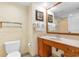 Bathroom features a spacious wooden vanity, a large mirror, towels, and a toilet at 603 S Ocean Blvd. # 1205, North Myrtle Beach, SC 29582