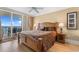 Comfortable bedroom with a large bed and balcony access with ocean views at 603 S Ocean Blvd. # 1205, North Myrtle Beach, SC 29582