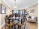 Dining area with seating for six, chandelier, and ocean view through large windows at 603 S Ocean Blvd. # 1205, North Myrtle Beach, SC 29582