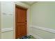 Hallway with wood paneled front door numbered 1204 and 1205 at 603 S Ocean Blvd. # 1205, North Myrtle Beach, SC 29582