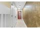 View of the hallway showing the tan wall and white tile flooring at 603 S Ocean Blvd. # 1205, North Myrtle Beach, SC 29582