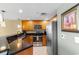This kitchen features modern appliances, including a stainless steel refrigerator and black countertops at 603 S Ocean Blvd. # 1205, North Myrtle Beach, SC 29582