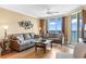 Bright living room with comfortable seating and ocean views through large windows at 603 S Ocean Blvd. # 1205, North Myrtle Beach, SC 29582