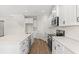 Well-equipped kitchen boasts stainless steel appliances, white cabinetry, and a functional center island at 605 Carter Reid Ct., Longs, SC 29568