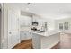 Modern kitchen features white cabinets, quartz countertops, stainless steel appliances, and a center island at 605 Carter Reid Ct., Longs, SC 29568