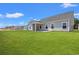 A spacious backyard features a covered patio and lush green lawn, perfect for outdoor entertaining at 609 Carter Reid Ct., Longs, SC 29568