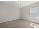 Small bedroom featuring soft carpet, neutral walls, and a window providing ample natural light at 609 Carter Reid Ct., Longs, SC 29568