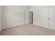 Bedroom with soft carpet, neutral walls, and double closet with an open doorway to a connected room at 609 Carter Reid Ct., Longs, SC 29568