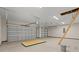Spacious two-car garage with white walls, concrete floors, and two automatic garage doors at 609 Carter Reid Ct., Longs, SC 29568