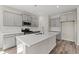 Modern kitchen with a large island, stainless steel appliances, and gray cabinets at 609 Carter Reid Ct., Longs, SC 29568