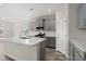 Well-lit kitchen with a center island, stainless steel appliances, and gray cabinets at 609 Carter Reid Ct., Longs, SC 29568