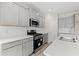 Modern kitchen featuring stainless steel appliances, gray cabinets, and a white backsplash at 609 Carter Reid Ct., Longs, SC 29568