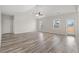 Bright and airy living room with high ceilings, fan, and wood-look floors at 609 Carter Reid Ct., Longs, SC 29568