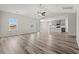 Open-concept living space with modern wood flooring and kitchen view at 609 Carter Reid Ct., Longs, SC 29568