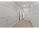 Walk-in closet featuring wire shelving with carpeted floor and an open doorway at 609 Carter Reid Ct., Longs, SC 29568