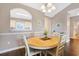 Bright dining area with hardwood floors, seating four, and a large chandelier at 6203 Catalina Dr. # 1832, North Myrtle Beach, SC 29582